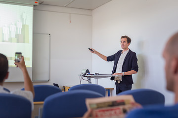 Image showing Student presenting his study work in front of whiteboard.