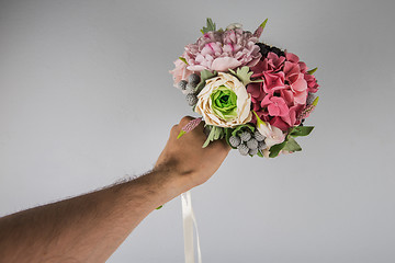 Image showing male hand giving wedding bouquet