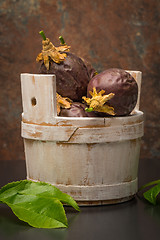 Image showing Passion fruits s on a wooden bucket