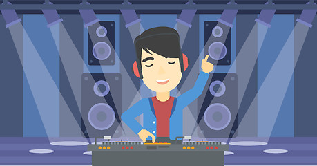 Image showing Smiling DJ mixing music on turntables.