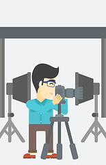 Image showing Photographer working with camera on tripod.