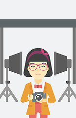 Image showing Smiling photographer holding camera.