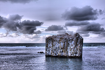 Image showing Pole in ocean. Rock with vertical walls. Basaltic parting, 