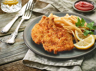 Image showing pork schnitzel and fried potatoes