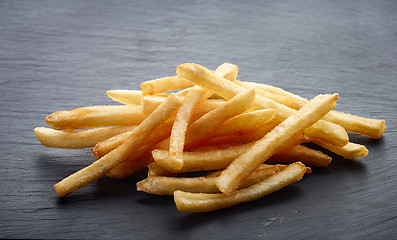 Image showing french fries on black stone background