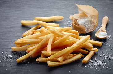 Image showing french fries on black stone background