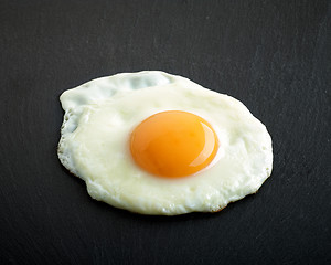 Image showing fried egg on black background