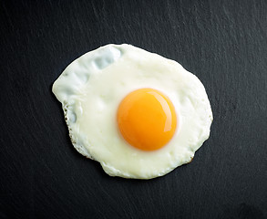 Image showing fried egg on black background