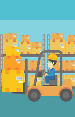 Image showing Warehouse worker moving load by forklift truck.