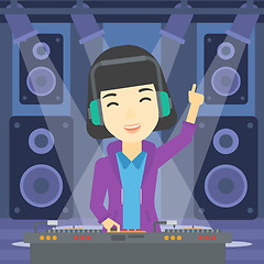 Image showing Smiling DJ mixing music on turntables.