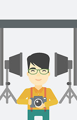 Image showing Photographer with camera in photo studio.