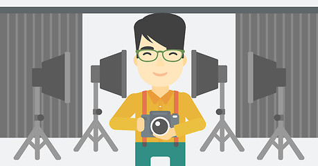 Image showing Photographer with camera in photo studio.