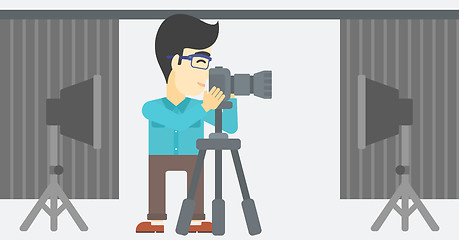 Image showing Photographer working with camera on tripod.