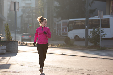 Image showing sporty woman jogging on morning