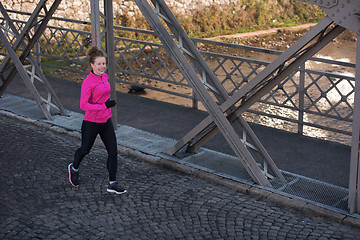 Image showing sporty woman jogging on morning
