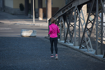 Image showing sporty woman jogging on morning