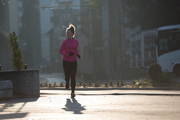 Image showing sporty woman jogging on morning