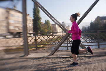 Image showing sporty woman jogging on morning