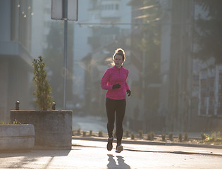 Image showing sporty woman jogging on morning