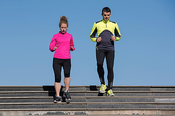 Image showing young  couple jogging on steps