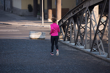 Image showing sporty woman jogging on morning