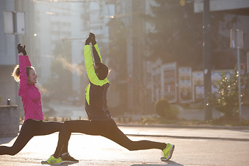 Image showing couple warming up before jogging