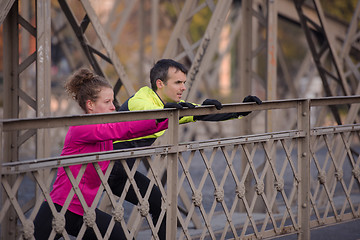 Image showing couple warming up before jogging