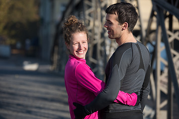 Image showing couple warming up before jogging