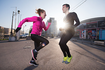 Image showing couple warming up before jogging