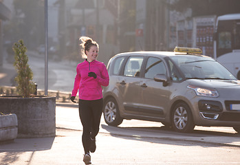 Image showing sporty woman jogging on morning