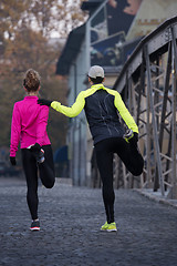 Image showing couple warming up before jogging