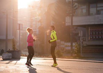 Image showing couple warming up before jogging