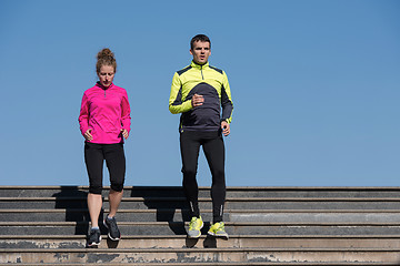 Image showing young  couple jogging on steps