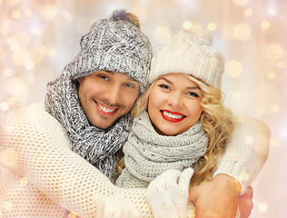 Image showing happy family couple in winter clothes hugging