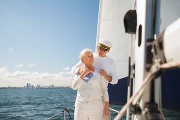 Image showing senior couple hugging on sail boat or yacht in sea