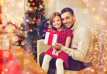 Image showing smiling father and daughter holding gift box