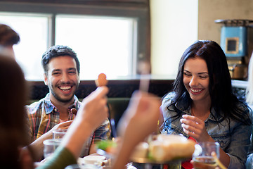 Image showing happy friends with beer eating at bar or pub