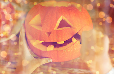 Image showing close up of woman with pumpkins at home