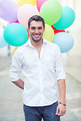 Image showing man with colorful balloons in the city