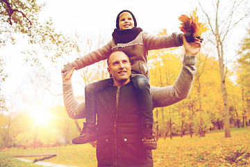 Image showing happy family having fun in autumn park