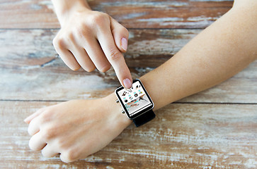 Image showing close up of hands with online shop on smart watch