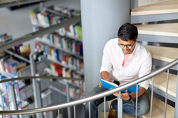 Image showing hindu student boy or man reading book at library