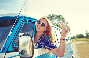 Image showing smiling young hippie woman driving minivan car