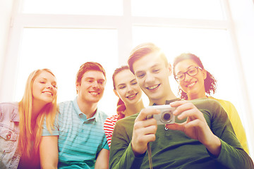 Image showing smiling students with digital camera at school