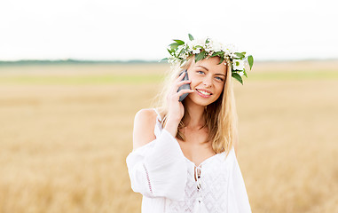 Image showing happy young woman calling on smartphone at country