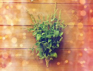 Image showing close up of fresh melissa bunch on wooden table