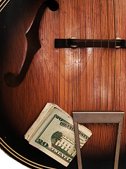 Image showing Vintage Acoustic Guitar And Money