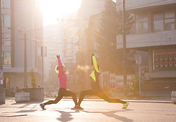 Image showing couple warming up before jogging