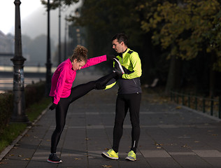 Image showing couple warming up before jogging