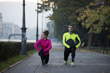 Image showing couple warming up before jogging